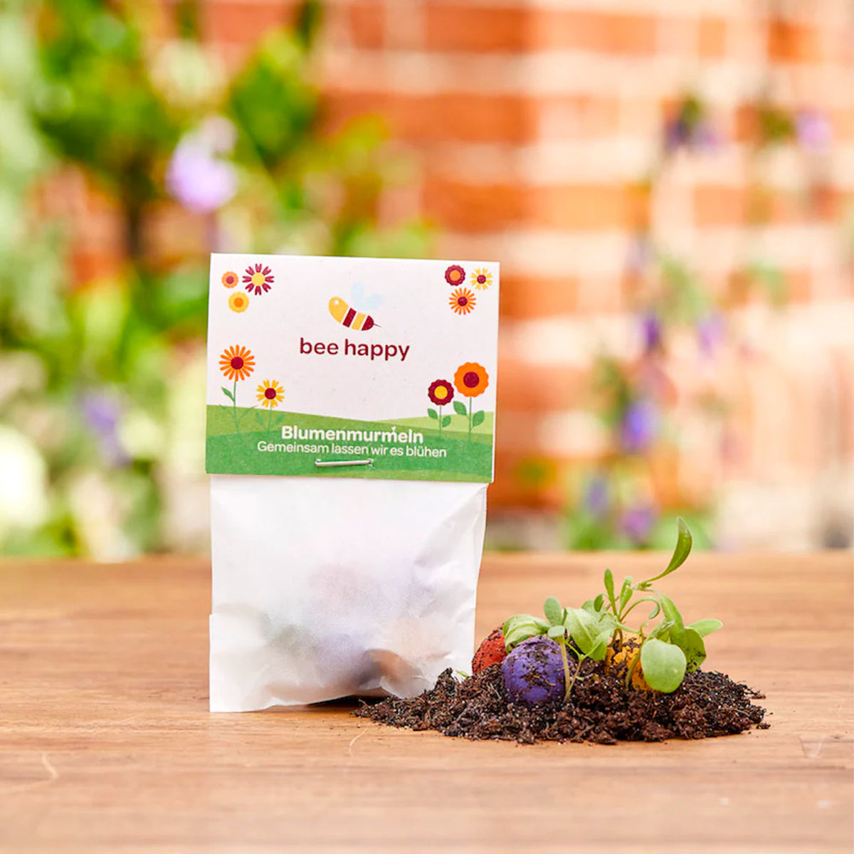 5 Blumenmurmeln im Pergamintütchen mit einem individuellen Werbereiter