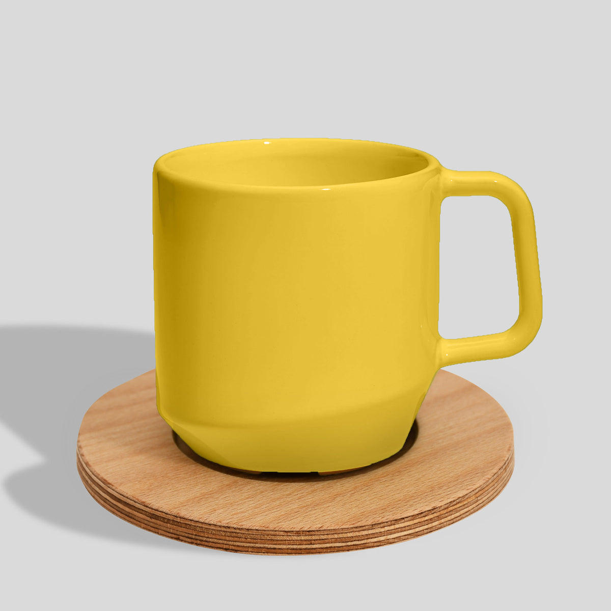 Keramiktasse 400 ml mit Eckhenkel auf Holzuntersetzer – Sonnengelb